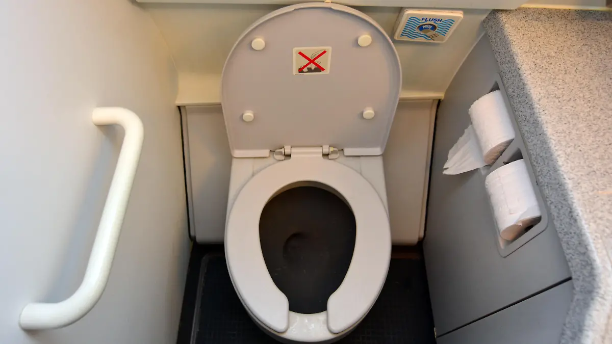 Aircraft lavatory toilets aboard a jetliner airplane.