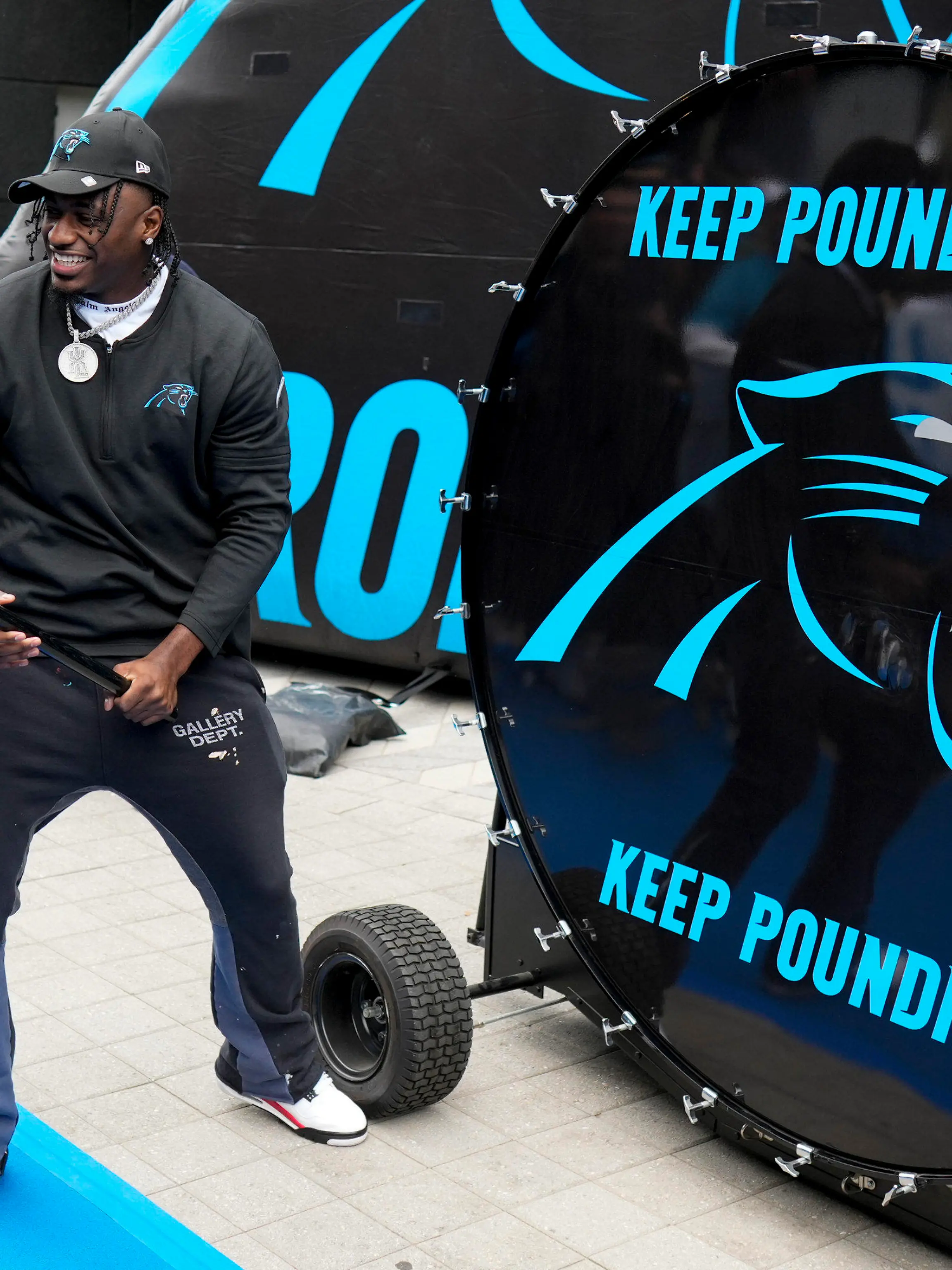 Carolina Panthers first round draft pick Xavier Legette beats the team drum before for an NFL football press conference on Friday, April 26, 2024, in Charlotte, N.C. (AP Photo/Chris Carlson)