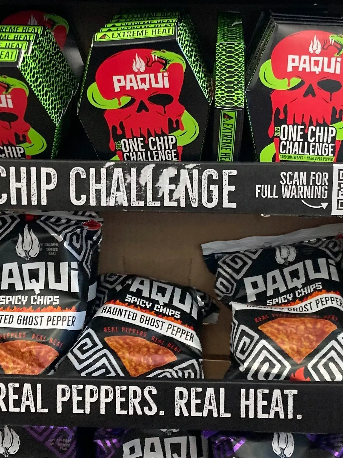 FILE - Paqui One Chip Challenge chips are displayed at a 7-Eleven store in Boston, Thursday, Sept. 7, 2023, before they were removed the following day. A medical examiner says a Massachusetts teen who participated in a spicy tortilla chip challenge died from ingesting a substance “with a high capsaicin concentration,” according to autopsy results The Associated Press obtained late Wednesday, May 15, 2024. Capsaicin is a chili pepper extract. Harris Wolobah died on Sept. 1, 2023, after eating the chip. (AP Photo/Steve LeBlanc, File)