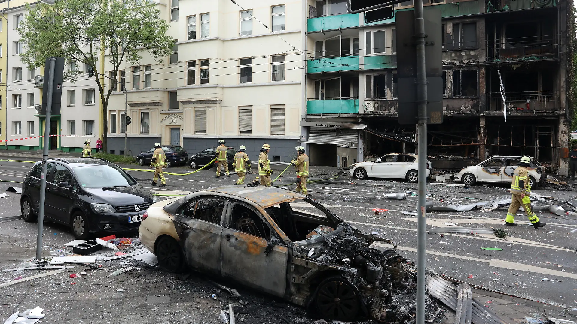 A damaged car stands opposite a destroyed building after an overnight explosion inside a kiosk killed three people and injured sixteen others in the western German city of Duesseldorf, Germany, May 16, 2024. REUTERS/Thilo Schmuelgen