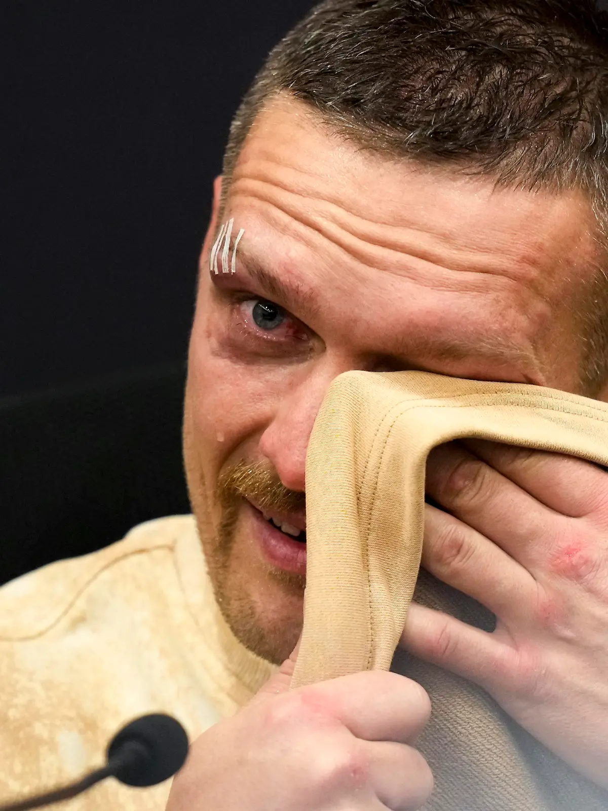 Ukraine's Oleksandr Usyk cries as he talks about his father during a news conference following his victory over Britain's Tyson Fury in their undisputed heavyweight championship boxing fight at the Kingdom Arena in Riyadh, Saudi Arabia, early Sunday, May 19, 2024. (AP Photo/Francisco Seco)