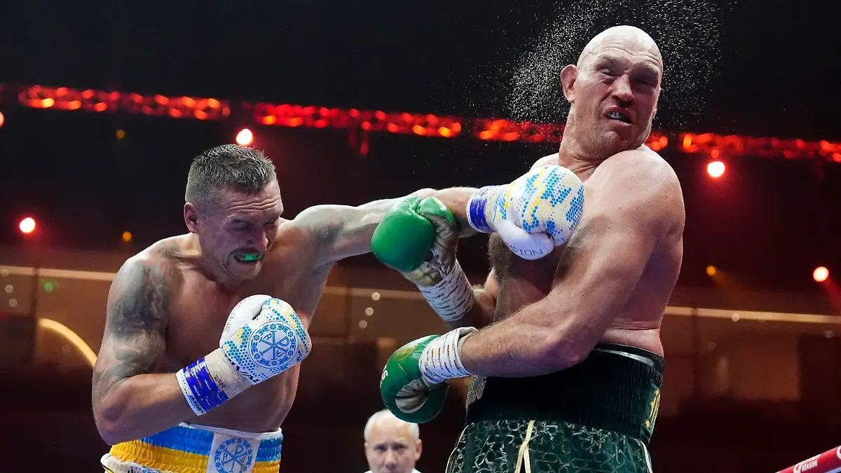 Britain’s Tyson Fury, right, takes a blow from Ukraine’s Oleksandr Usyk during their undisputed heavyweight world championship boxing fight at the Kingdom Arena in Riyadh, Saudi Arabia, Sunday, May 19, 2024. (Nick Potts/PA via AP)
