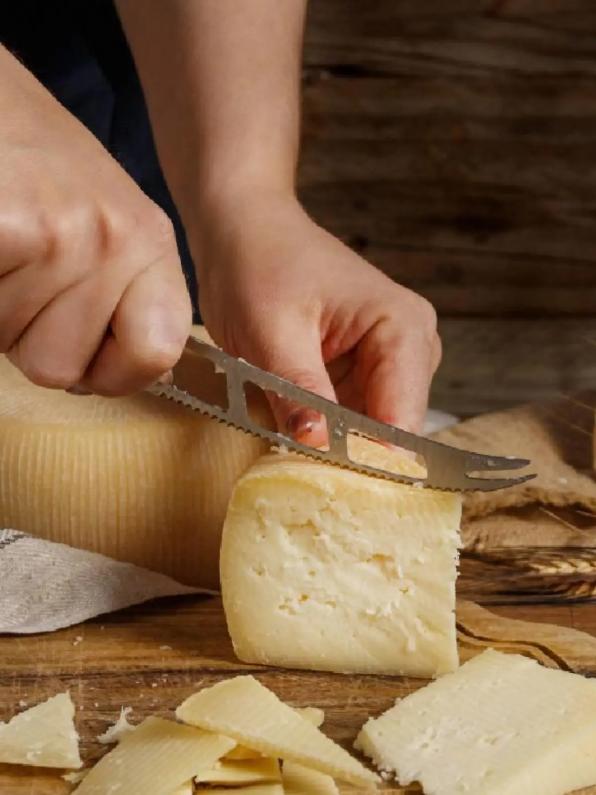 Eine Frau schneidet Käse.