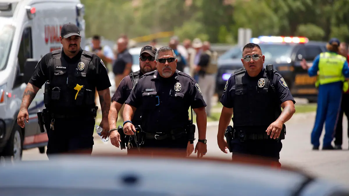 Police walk near Robb Elementary School following a shooting, Tuesday, May 24, 2022, in Uvalde, Texas. (AP Photo/Dario Lopez-Mills)