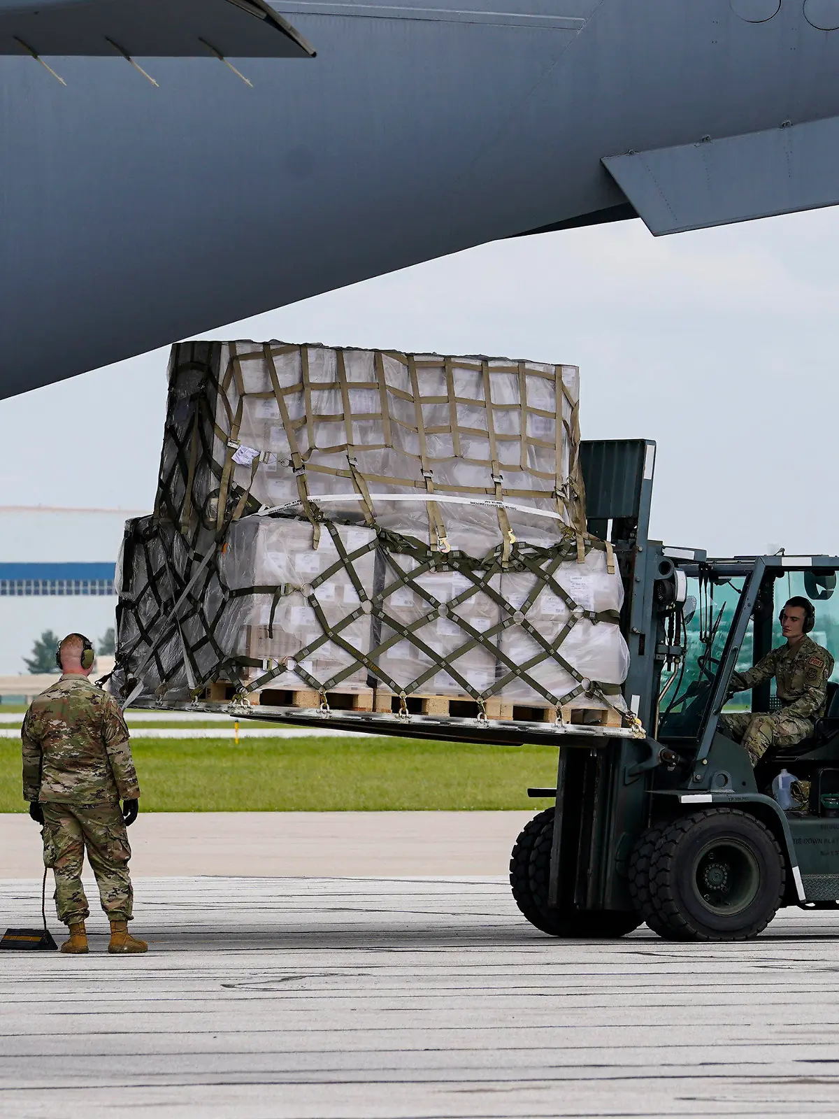 Crew members of an Air Force C-17 unload a plane load of baby formula at the Indianapolis International Airport in Indianapolis, Sunday, May 22, 2022. The 132 pallets of Nestlé Health Science Alfamino Infant and Alfamino Junior formula arrived from Ramstein Air Base in Germany. (AP Photo/Michael Conroy)