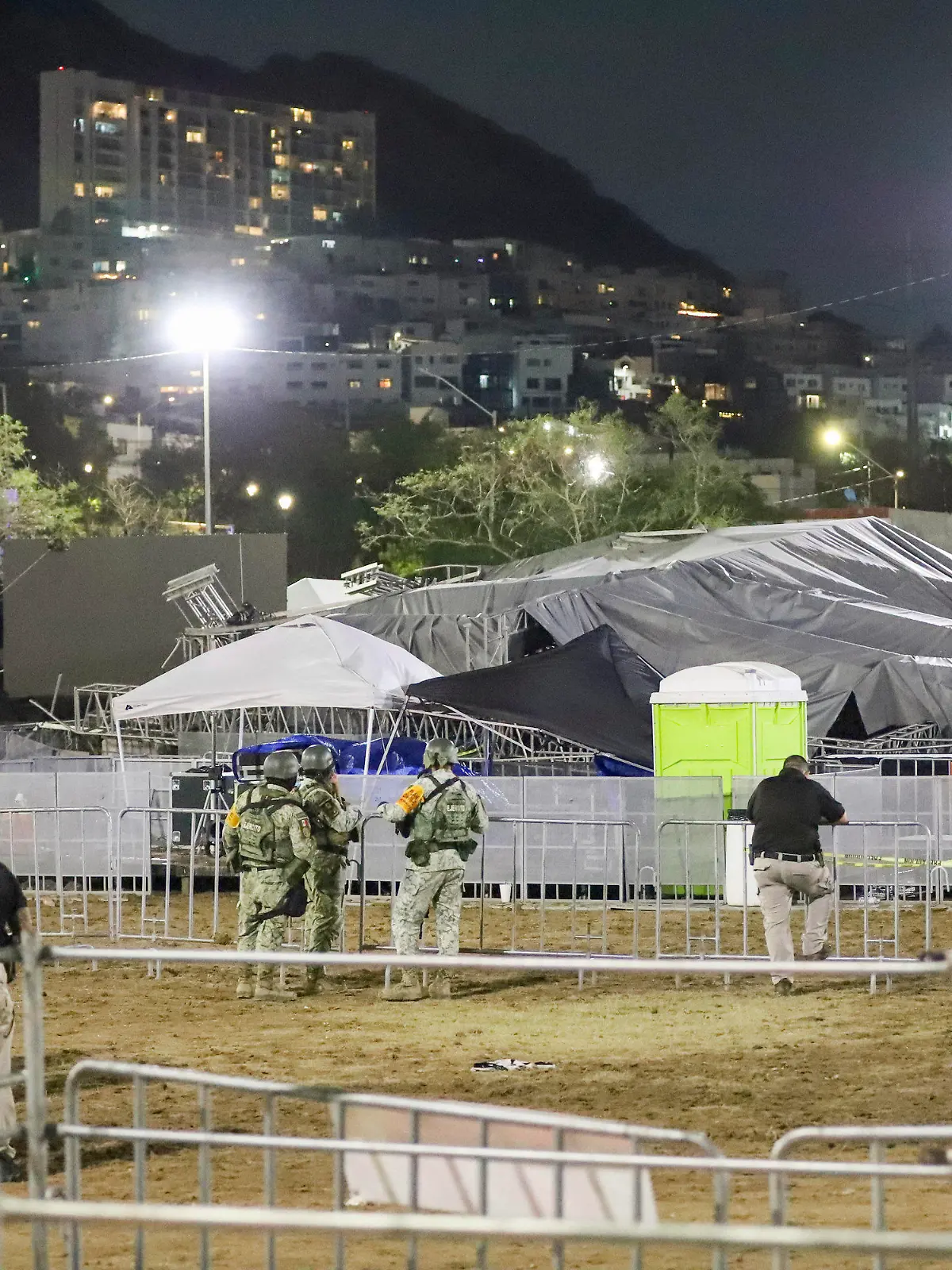 Security forces stand around a stage that collapsed due to a gust of wind during an event attended by presidential candidate Jorge Álvarez Máynez in San Pedro Garza García, on the outskirts of Monterey, Mexico, Wednesday, May 22, 2024. President Andres Manuel Lopez Obrador confirmed that multiple people were killed and at least a dozen were injured. (AP Photo/Alberto Lopez)