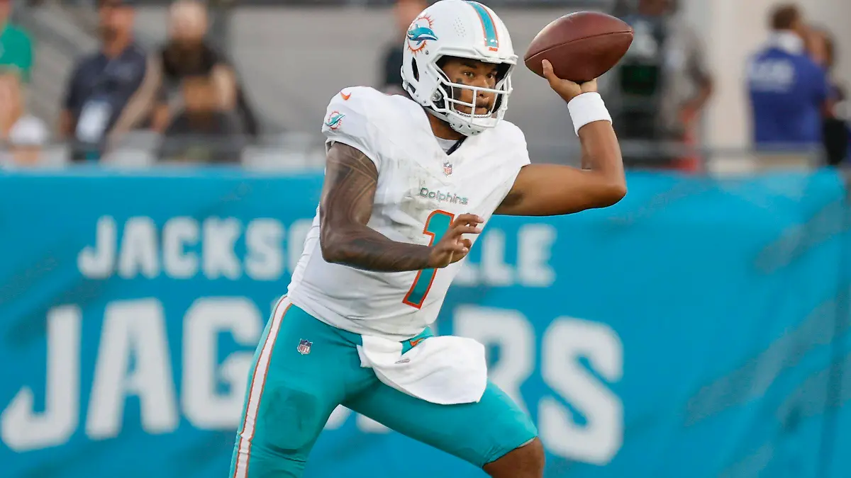 Miami Dolphins quarterback Tua Tagovailoa (1) sets up to pass during the first quarter of the team's preseason NFL football game against the Jacksonville Jaguars Saturday, Aug. 26, 2023, in Jacksonville, Fla. (Al Diaz/Miami Herald via AP)