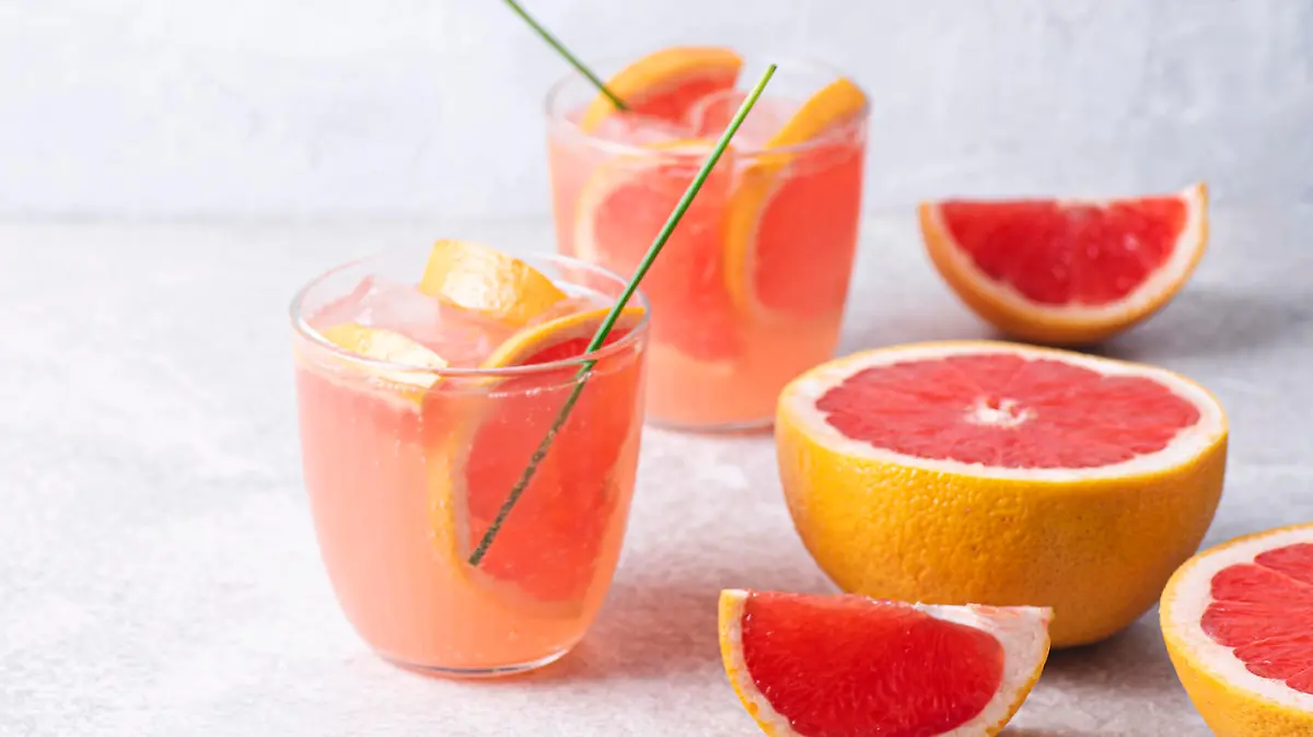 Refreshing low alcohol cocktail with grapefruit on a fresh stone background. Fruity light cocktails, eco friendly natural style, soft pastel colors, copy space