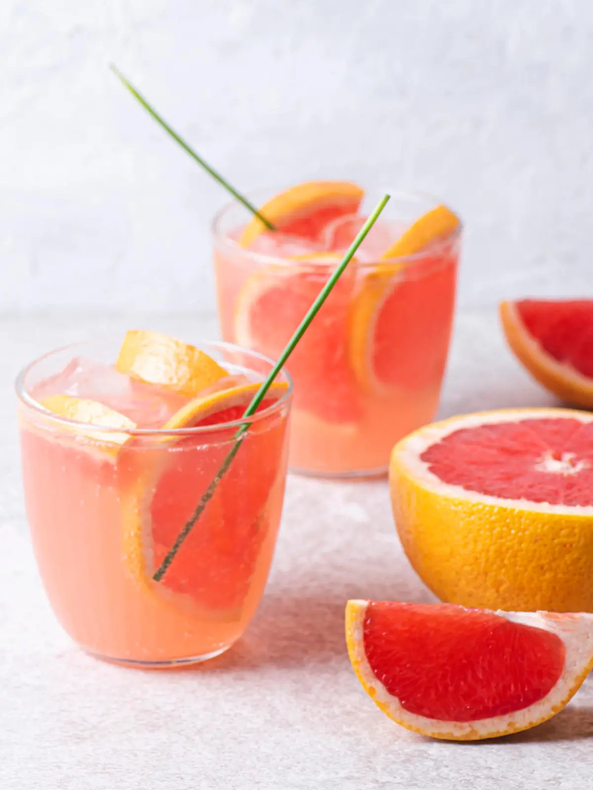 Refreshing low alcohol cocktail with grapefruit on a fresh stone background. Fruity light cocktails,  eco friendly  natural style, soft pastel colors, copy space