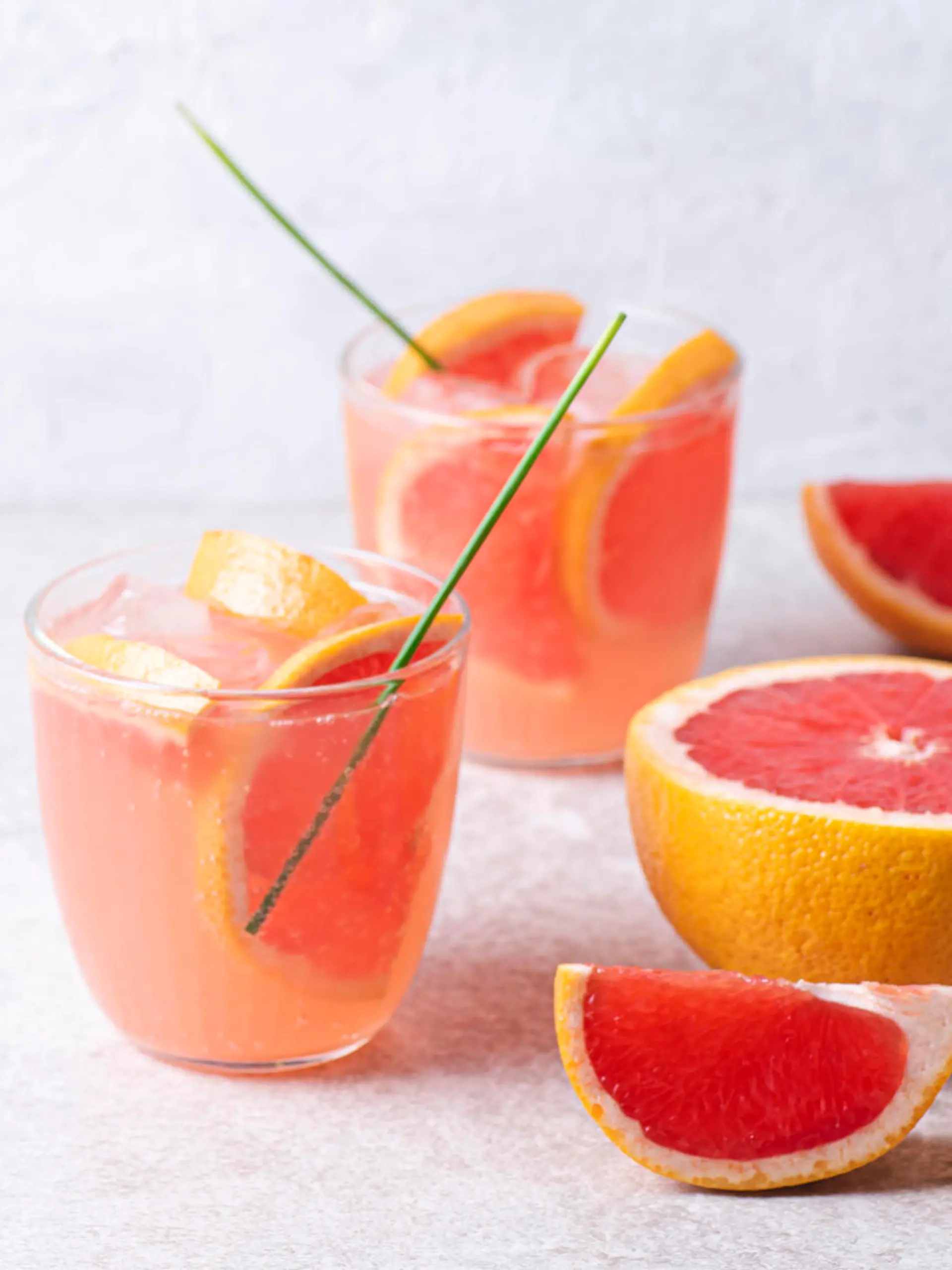 Refreshing low alcohol cocktail with grapefruit on a fresh stone background. Fruity light cocktails,  eco friendly  natural style, soft pastel colors, copy space