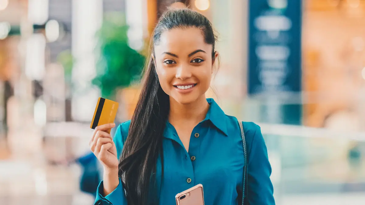 Young woman with shopping bags and credit card