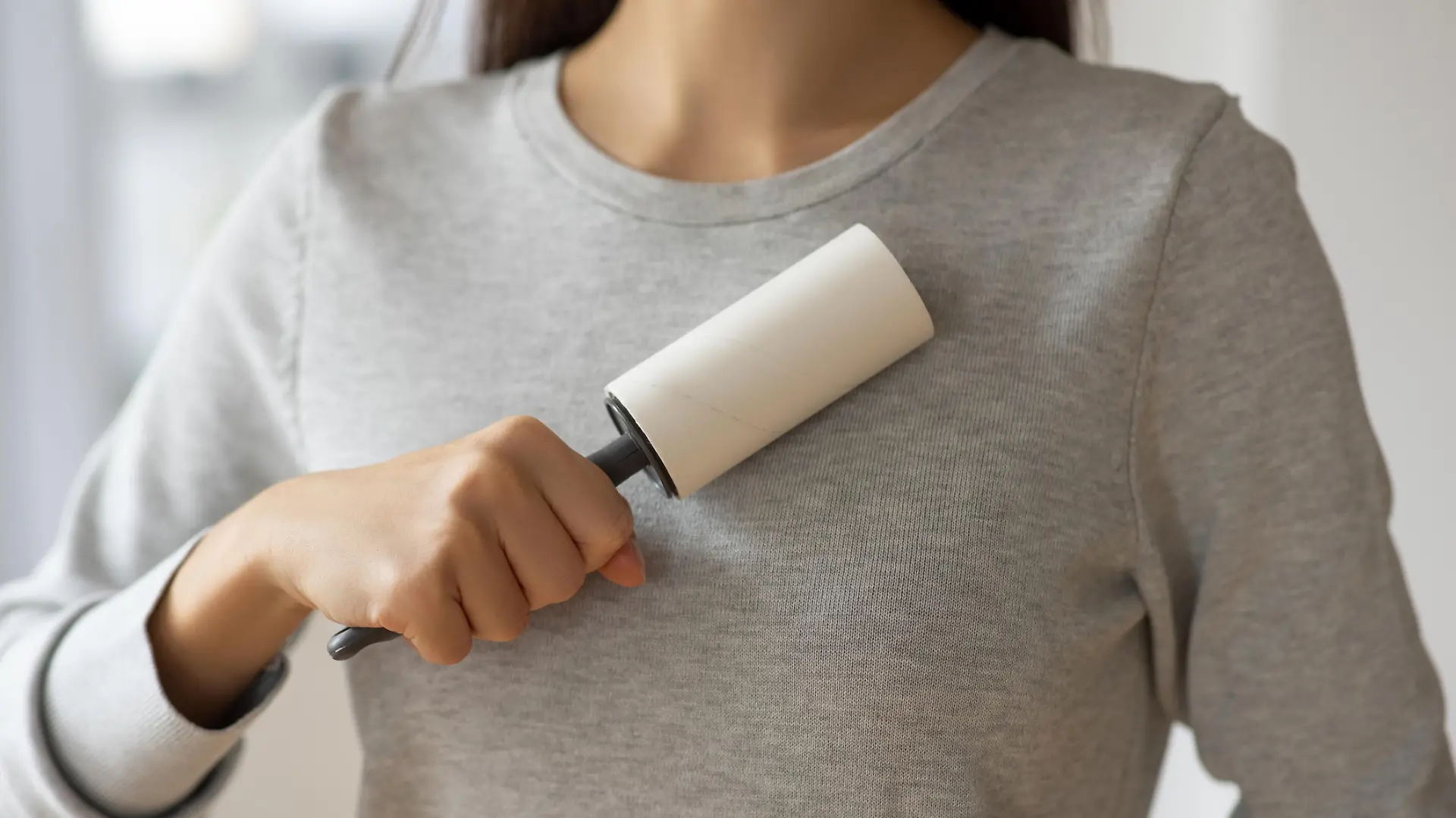 Sticky roller to clean her sweater