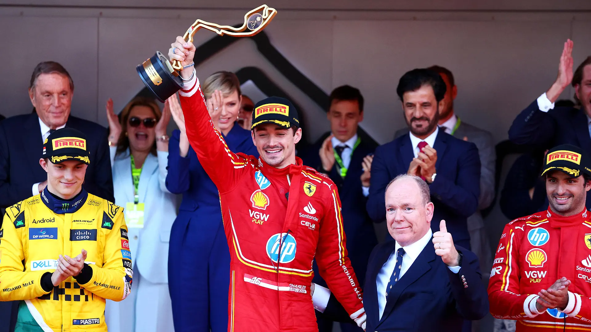 MONTE-CARLO, MONACO - MAY 26: Race winner Charles Leclerc of Monaco and Ferrari celebrates with Prince Albert of Monaco on the podium during the F1 Grand Prix of Monaco at Circuit de Monaco on May 26, 2024 in Monte-Carlo, Monaco. (Photo by Clive Rose/Getty Images)