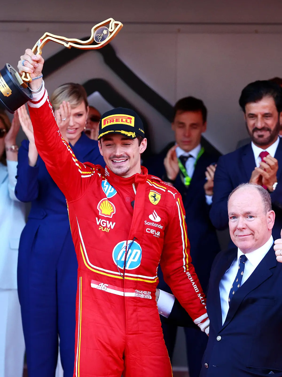 MONTE-CARLO, MONACO - MAY 26: Race winner Charles Leclerc of Monaco and Ferrari celebrates with Prince Albert of Monaco on the podium during the F1 Grand Prix of Monaco at Circuit de Monaco on May 26, 2024 in Monte-Carlo, Monaco. (Photo by Clive Rose/Getty Images)