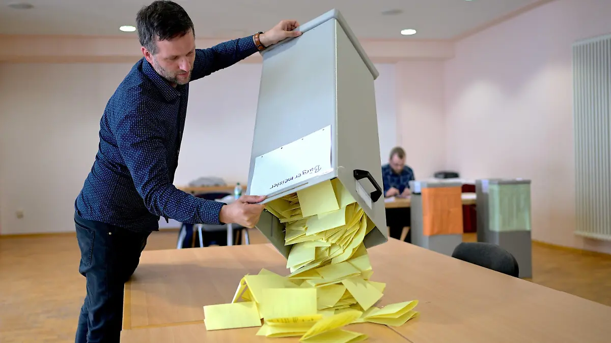26.05.2024, Thüringen, Arnstadt: Der Wahlvorsteher im Wahllokal für den Wahlkreis 114, Miklos Szatmari, schüttet die Wahlurne für die Auszählung der Stimmzettel für Bürgermeisterwahl in Arnstadt aus. In Thüringen werden eine Vielzahl von Stadt- und Gemeinderäten, 94 Oberbürgermeister und Bürgermeister sowie 13 Landräte gewählt. Die Stichwahlen sind für den Tag der Europawahl (9. Juni) geplant. Foto: Jacob Schröter/dpa +++ dpa-Bildfunk +++
