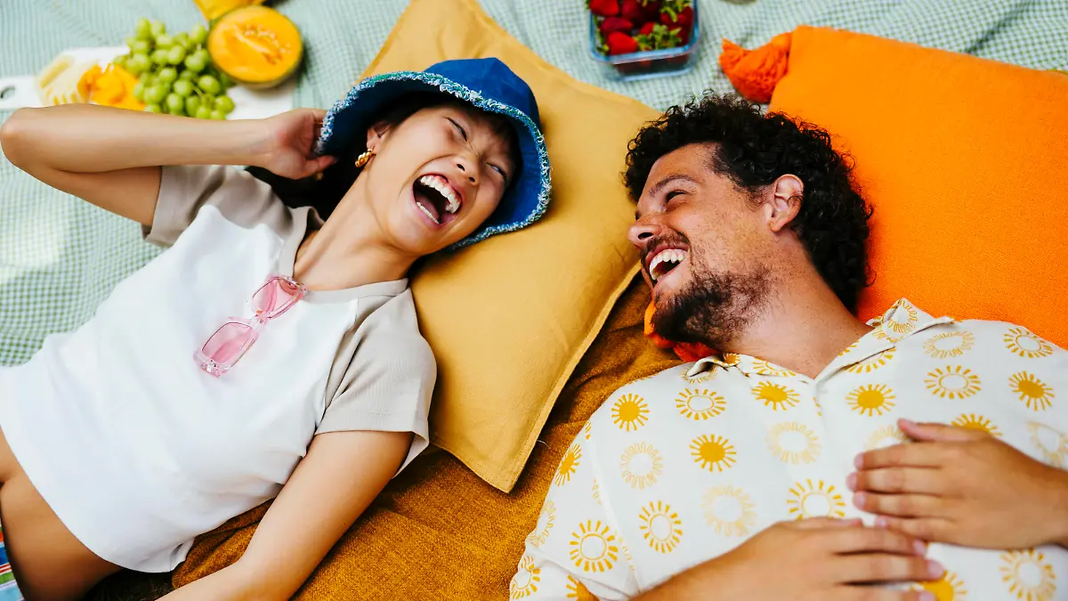 Happy friends enjoying together and lying on picnic blanket model released, Symbolfoto, EBSF03762