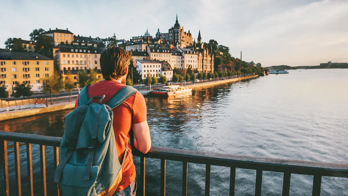Tourist man sightseeing Stockholm city enjoying view traveling lifestyle summer vacations in Sweden