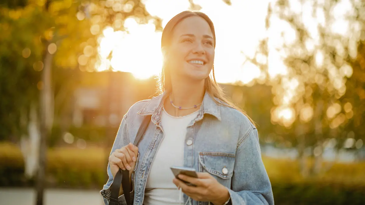 Young blond hair woman on the street using a mobile phone