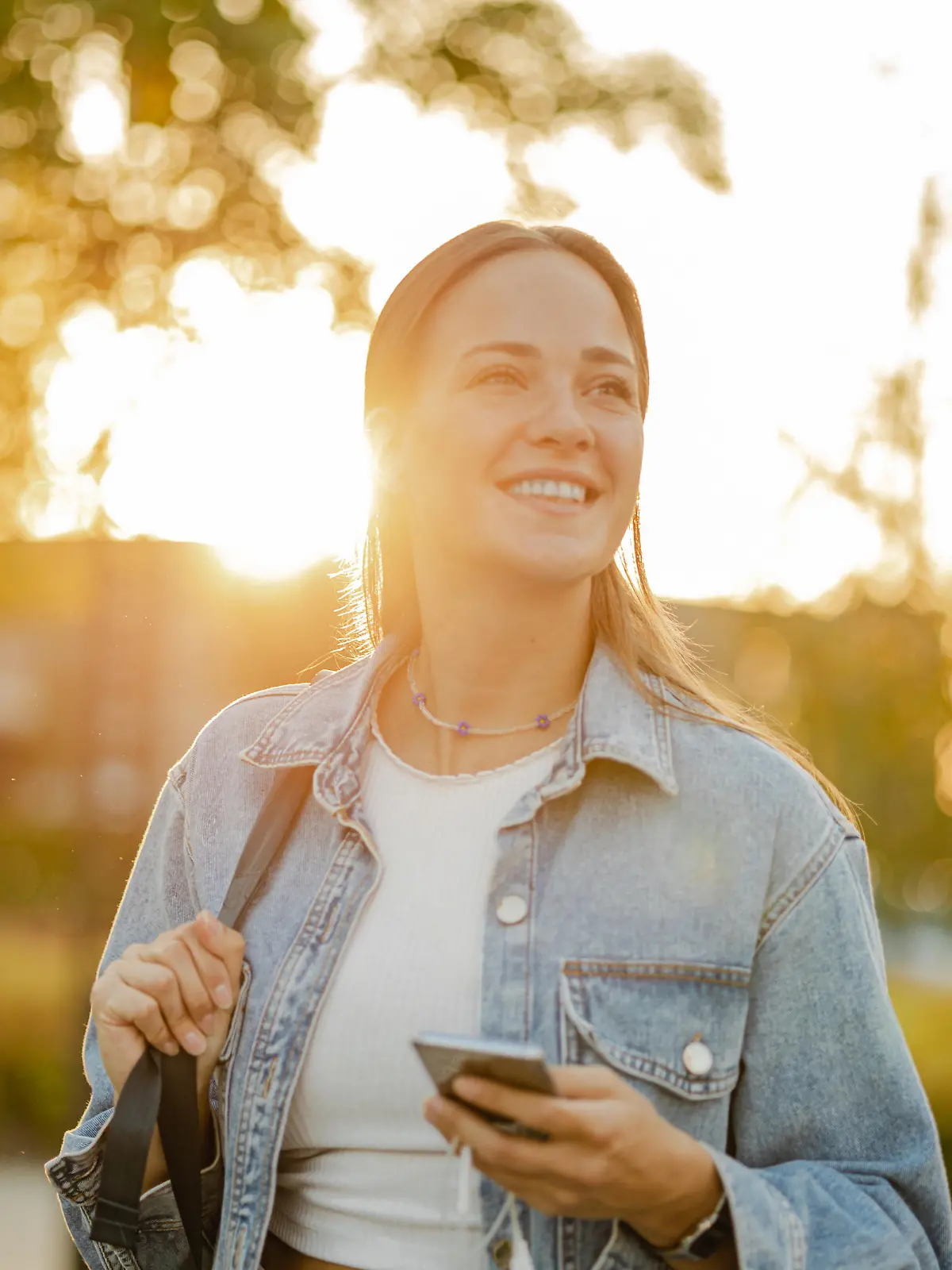 Young blond hair woman on the street using a mobile phone