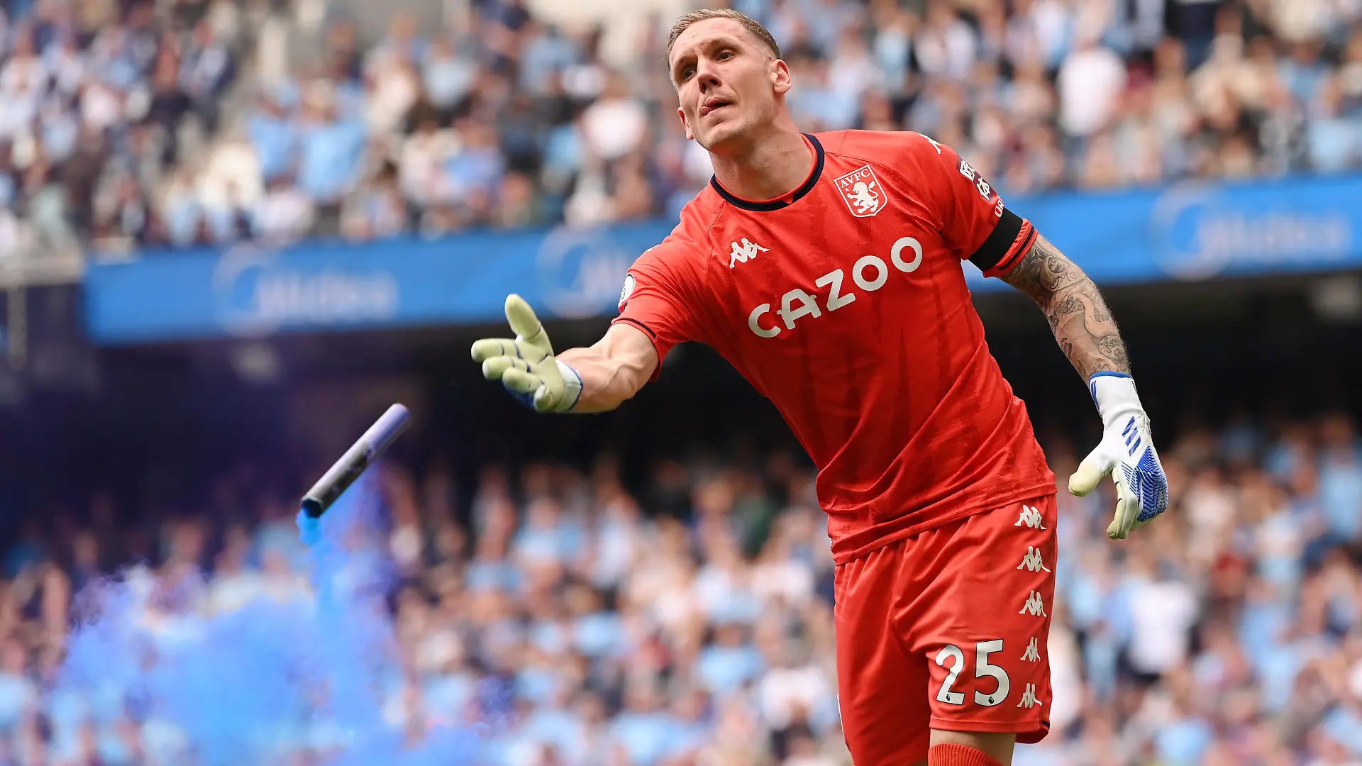 MANCHESTER, ENGLAND - MAY 22: Robin Olsen of Aston Villa removes a flare from the pitch during the Premier League match between Manchester City and Aston Villa at Etihad Stadium on May 22, 2022 in Manchester, England. (Photo by Stu Forster/Getty Images)