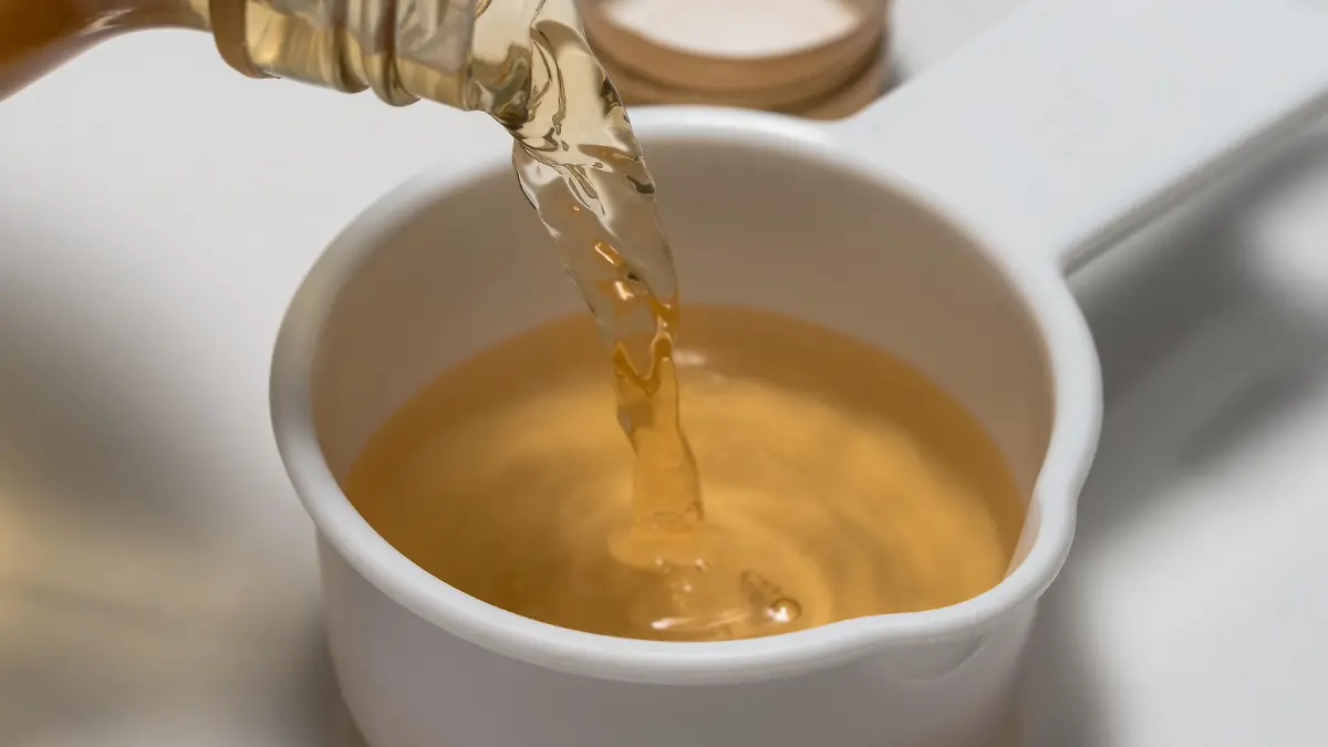 Pouring Apple Cider Vinegar in a Measuring Cup