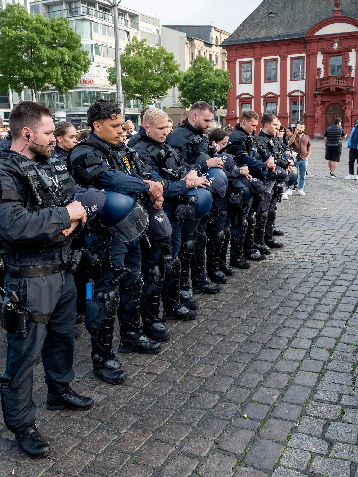 German police officers commemorate a colleague in Mannheim Germany, after learning that a police officer, who was stabbed two days ago there has died on Sunday, June 2, 2024. (AP Photo/Michael Probst)