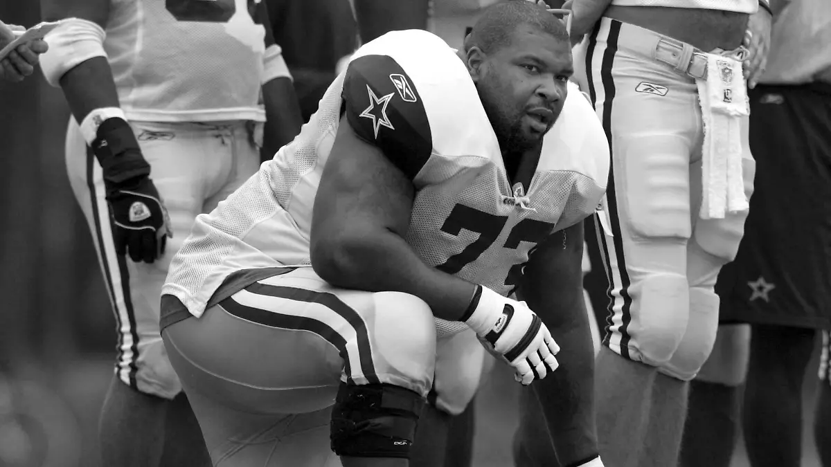 FILE - Dallas Cowboys' Larry Allen takes a knee during NFL training camp, Aug. 1, 2005, in Oxnard, Calif. Allen, one of the most dominant offensive linemen in the NFL during a 12-year career spent mostly with the Dallas Cowboys, died suddenly on Sunday, June 2, 2024, while on vacation with his family in Mexico, the Cowboys said. He was 52. (Irwin Thompson/The Dallas Morning News via AP, File)