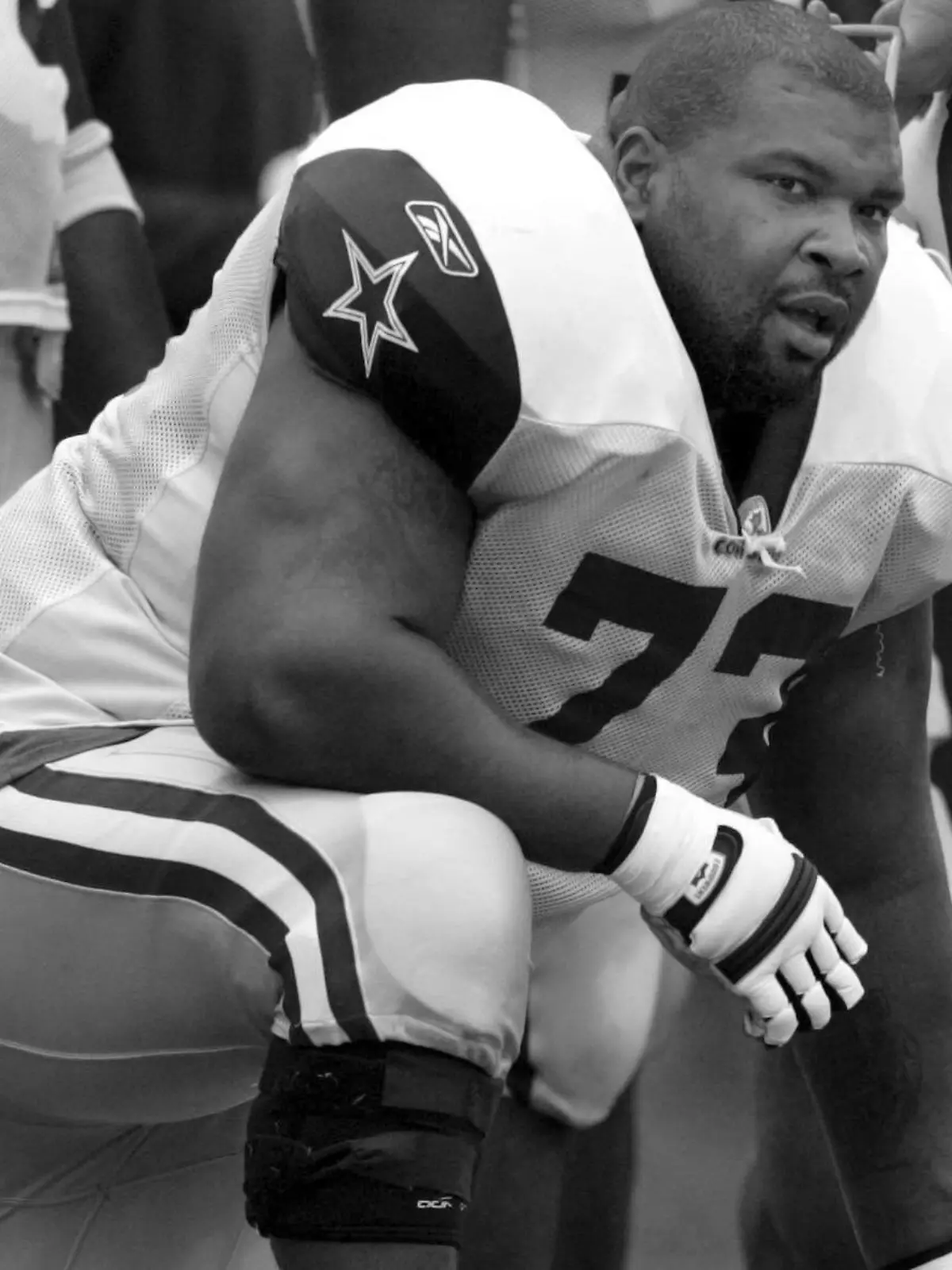 FILE - Dallas Cowboys' Larry Allen takes a knee during NFL training camp, Aug. 1, 2005, in Oxnard, Calif. Allen, one of the most dominant offensive linemen in the NFL during a 12-year career spent mostly with the Dallas Cowboys, died suddenly on Sunday, June 2, 2024, while on vacation with his family in Mexico, the Cowboys said. He was 52. (Irwin Thompson/The Dallas Morning News via AP, File)
