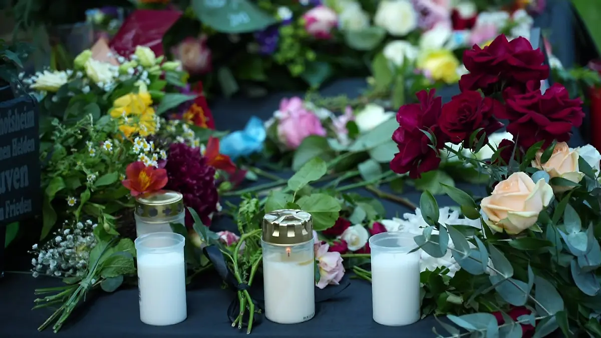 Viele Trauernde legen Blumen ab und zünden Kerzen an.