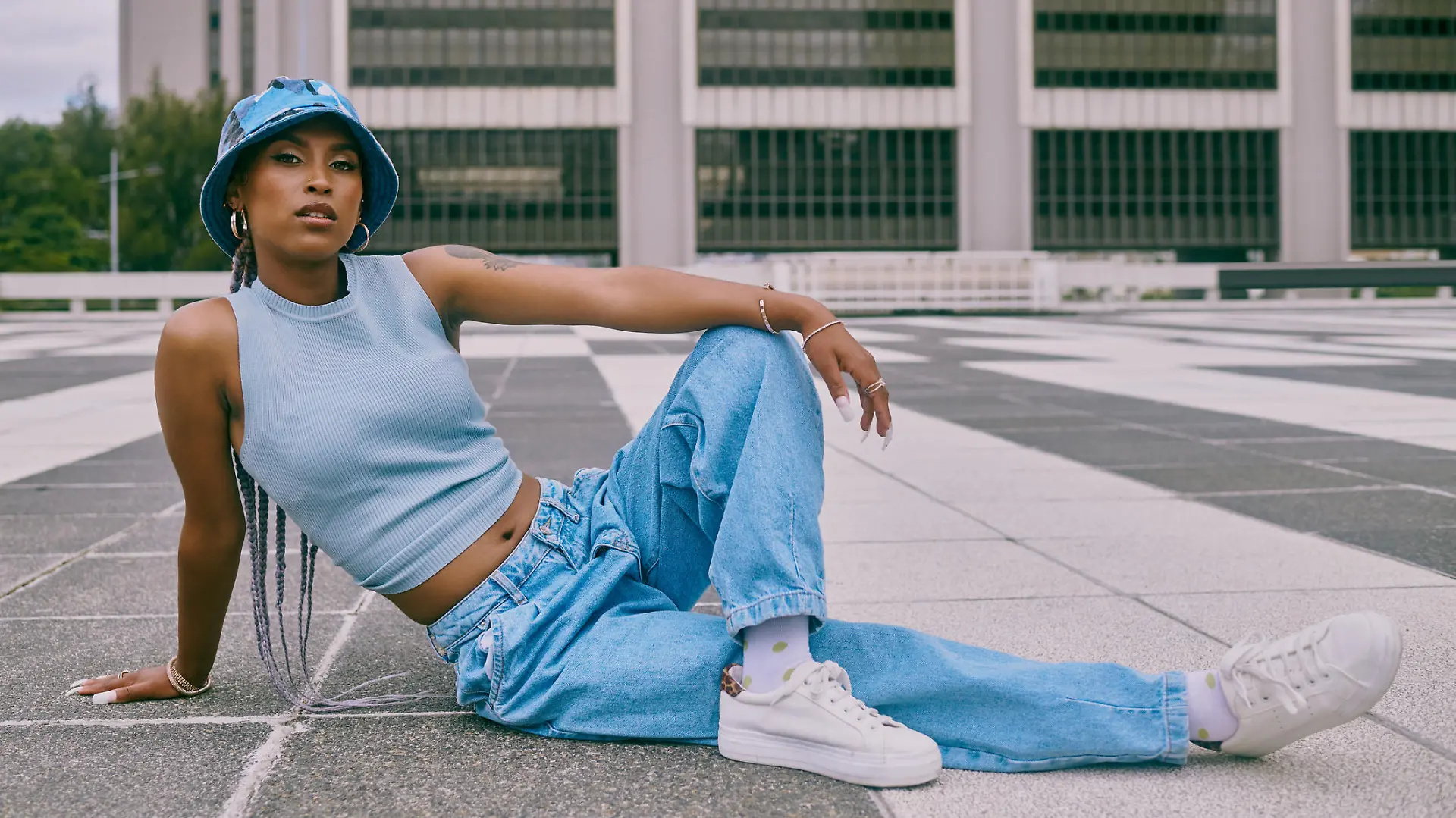 Shot of a trendy young woman posing against a city background
