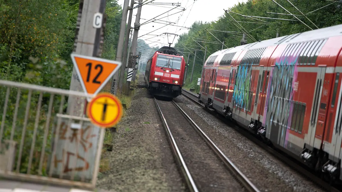 ARCHIV - 16.09.2021, Schleswig-Holstein, Ahrensburg: Zwei Regionalzüge der Deutschen Bahn (DB) begegnen sich vor einem Bahnhof. (zu dpa: «Zug fährt in Wismar über Bahnsteig hinaus · 100 000 Euro Schaden») Foto: Jonas Walzberg/dpa +++ dpa-Bildfunk +++
