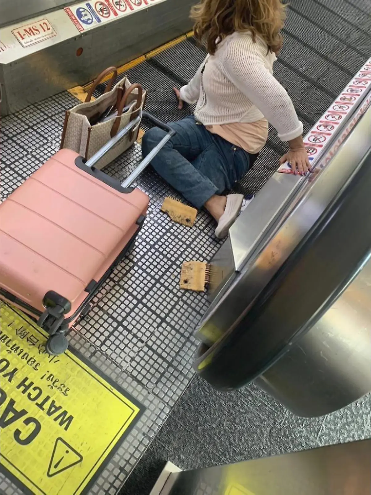 Eine Frau (57) bleibt am Flughafen Bangkok in einem Fahrsteig stecken.