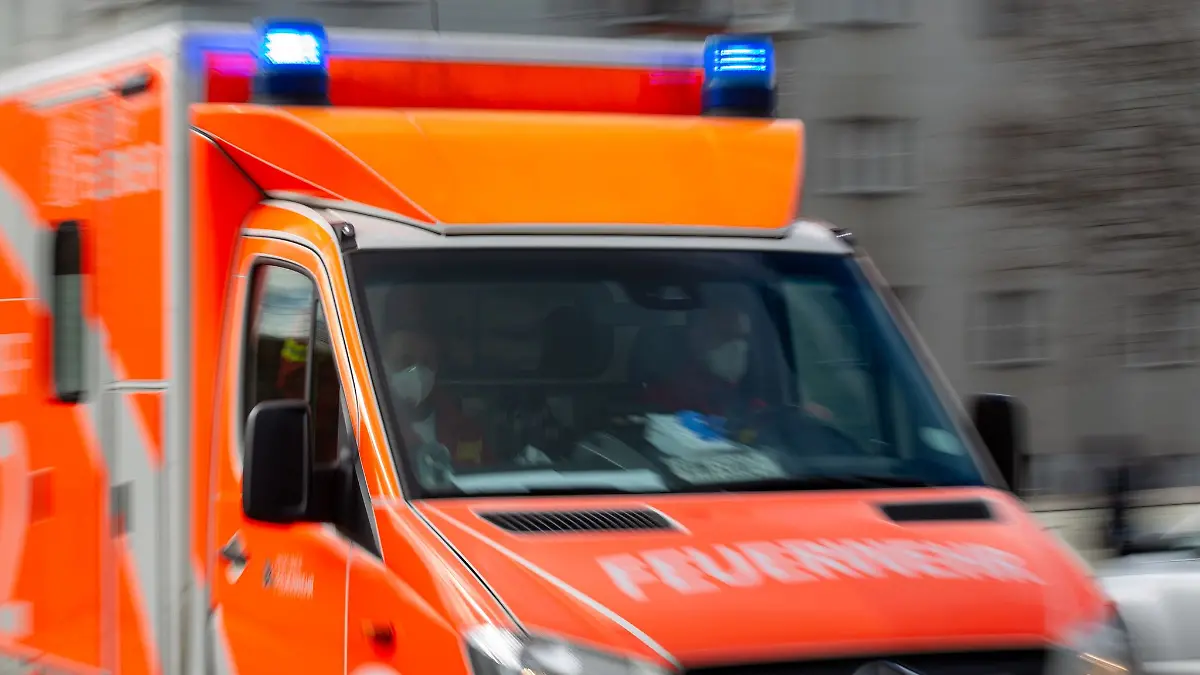 Ein Rettungswagen der Feuerwehr fährt auf einer Straße.