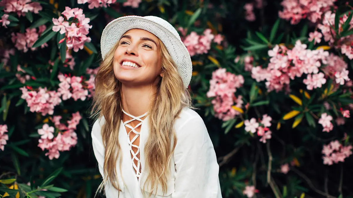 Beautiful girl on the background of spring bush