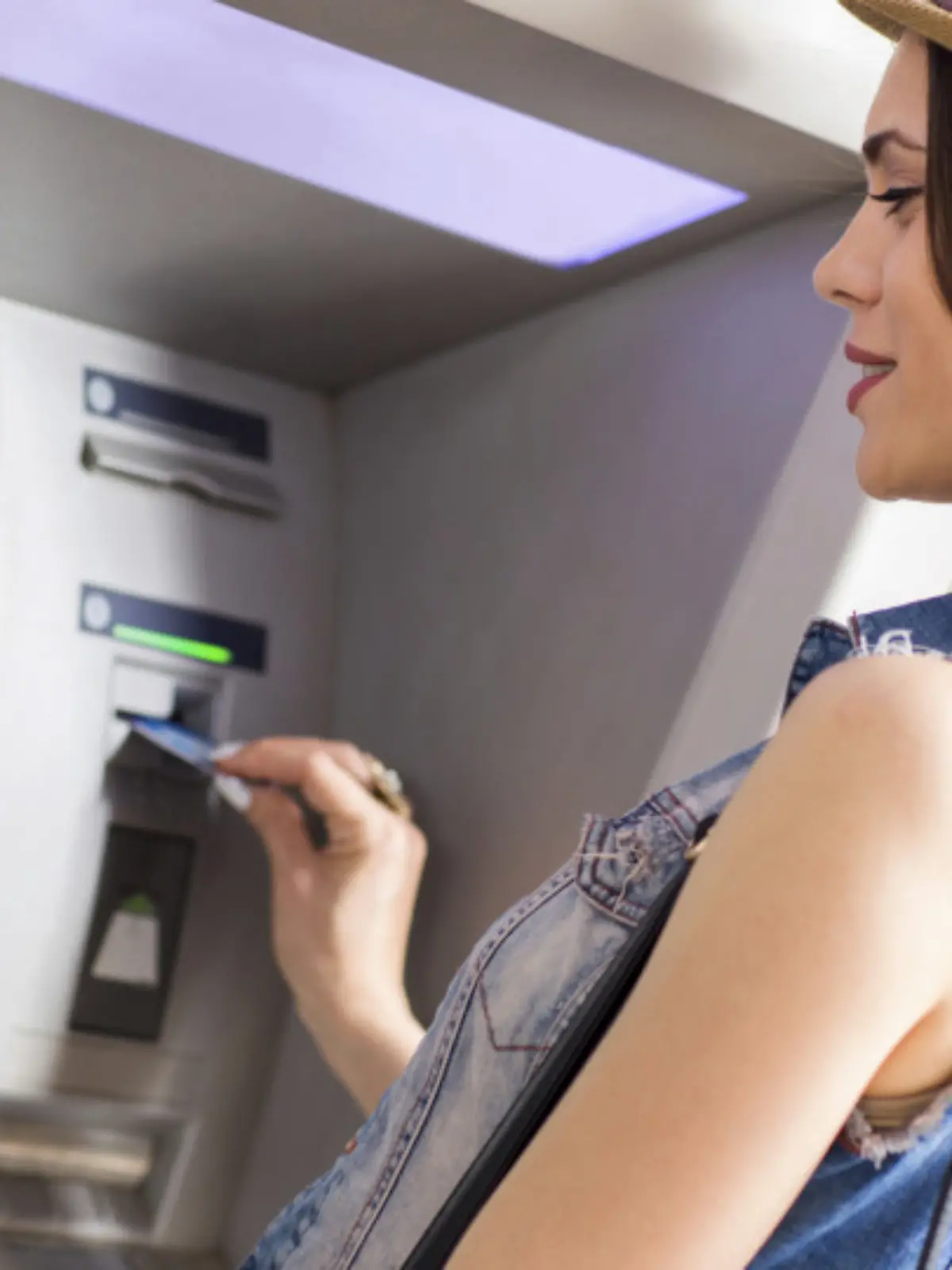 Young woman withdrawing money at the ATM.