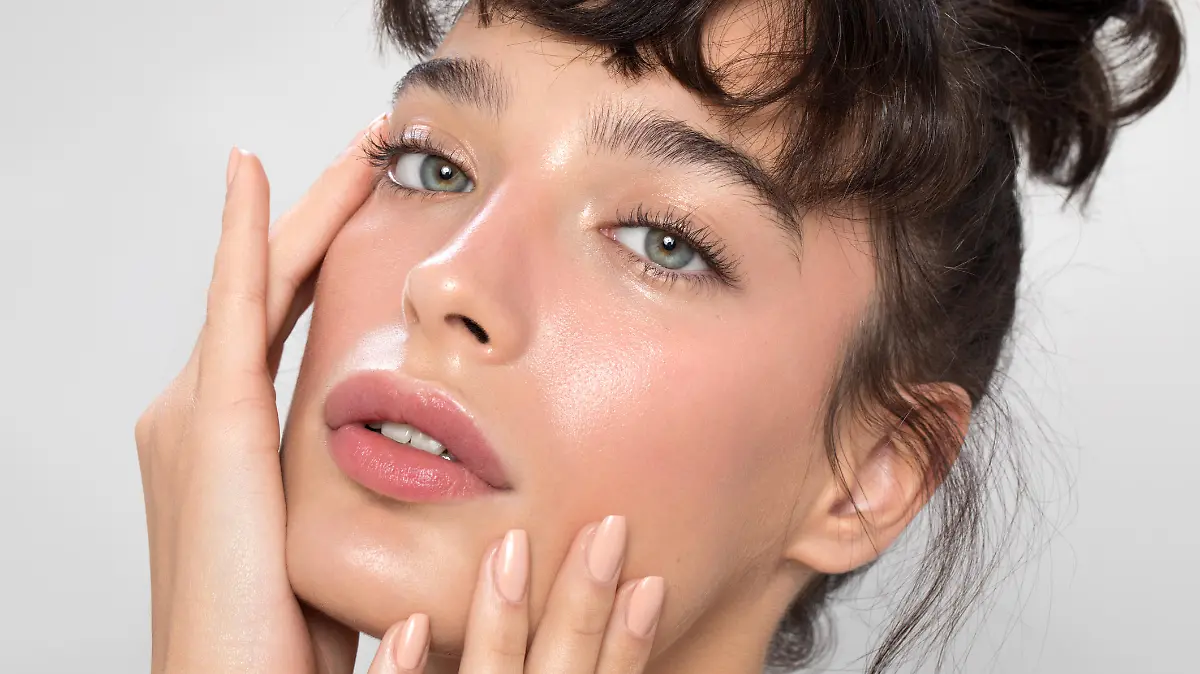 Close up studio shot of a beautiful woman with perfect skin, she touching her face