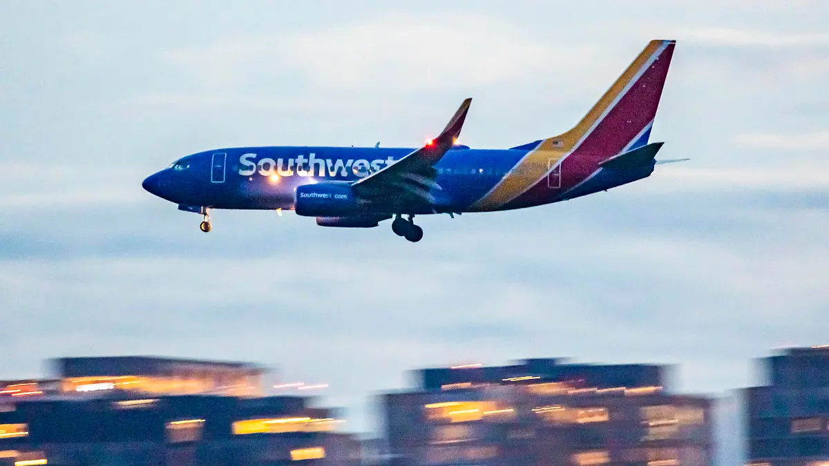 Southwest Airlines Boeing 737-700 aircraft as seen landing at dusk time at Ronald Reagan Washington National Airport DCA in Arlington County, Virginia over the Potomac River in the United States of America flying over water and buildings. The arriving B737 passenger airplane has the registration tail number N750SA and is powered by 2x CFMI jet engines. Southwest airline is the world's largest low-cost carrier with headquarters in Dallas Texas a fleet size of 793 planes. Washington DC, USA on May 2023 (Photo by Nicolas Economou/NurPhoto via Getty Images)