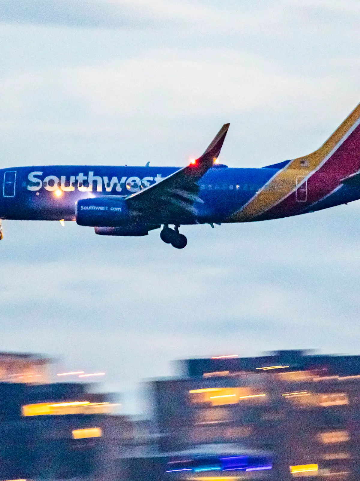 Southwest Airlines Boeing 737-700 aircraft as seen landing at dusk time at Ronald Reagan Washington National Airport DCA in Arlington County, Virginia over the Potomac River in the United States of America flying over water and buildings. The arriving B737 passenger airplane has the registration tail number N750SA and is powered by 2x CFMI jet engines. Southwest airline is the world's largest low-cost carrier with headquarters in Dallas Texas a fleet size of 793 planes. Washington DC, USA on May 2023 (Photo by Nicolas Economou/NurPhoto via Getty Images)