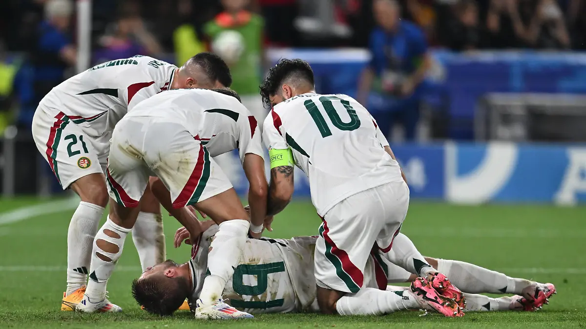 STUTTGART, GERMANY - JUNE 23: Barnabas Varga of Hungary lies on the ground and is assisted by teammates after a collision with goalkeeper Angus Gunn of Scotland during the UEFA EURO, EM, Europameisterschaft,Fussball 2024 group stage match between Scotland and Hungary at Stuttgart Arena on June 23, 2024 in Stuttgart, Germany. Photo by Sebastian Frej Scotland v Hungary: Group A - UEFA EURO 2024 Copyright: xSebastianxFrejx