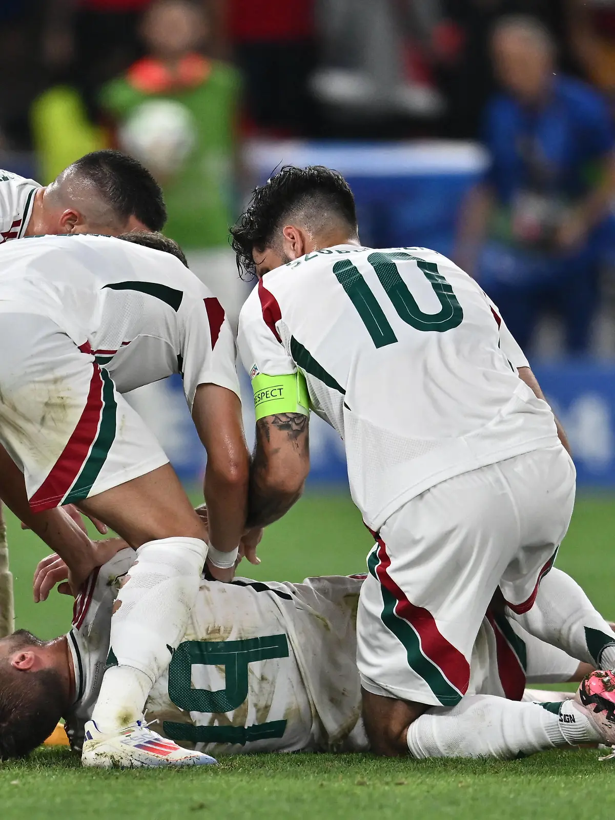 STUTTGART, GERMANY - JUNE 23: Barnabas Varga of Hungary lies on the ground and is assisted by teammates after a collision with goalkeeper Angus Gunn of Scotland during the UEFA EURO, EM, Europameisterschaft,Fussball 2024 group stage match between Scotland and Hungary at Stuttgart Arena on June 23, 2024 in Stuttgart, Germany. Photo by Sebastian Frej Scotland v Hungary: Group A - UEFA EURO 2024 Copyright: xSebastianxFrejx