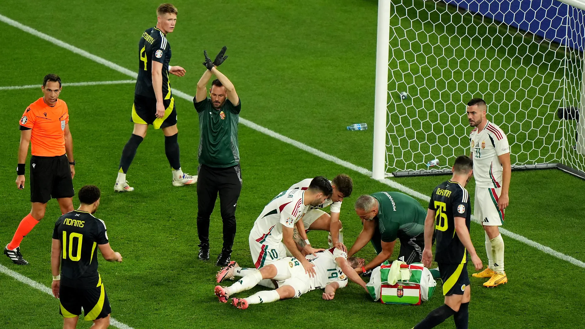 Scotland vs Hungary - UEFA EURO, EM, Europameisterschaft,Fussball 2024 - Group A - Stuttgart Arena Hungary s Barnabas Varga bottom is assisted by his team mates and medical staff after colliding with Scotland goalkeeper Angus Gunn not pictured during the UEFA Euro 2024 Group A match at the Stuttgart Arena in Stuttgart, Germany. Picture date: Sunday June 23, 2024. Use subject to restrictions. Editorial use only, no commercial use without prior consent from rights holder. PUBLICATIONxNOTxINxUKxIRL Copyright: xBradleyxCollyerx 76631265