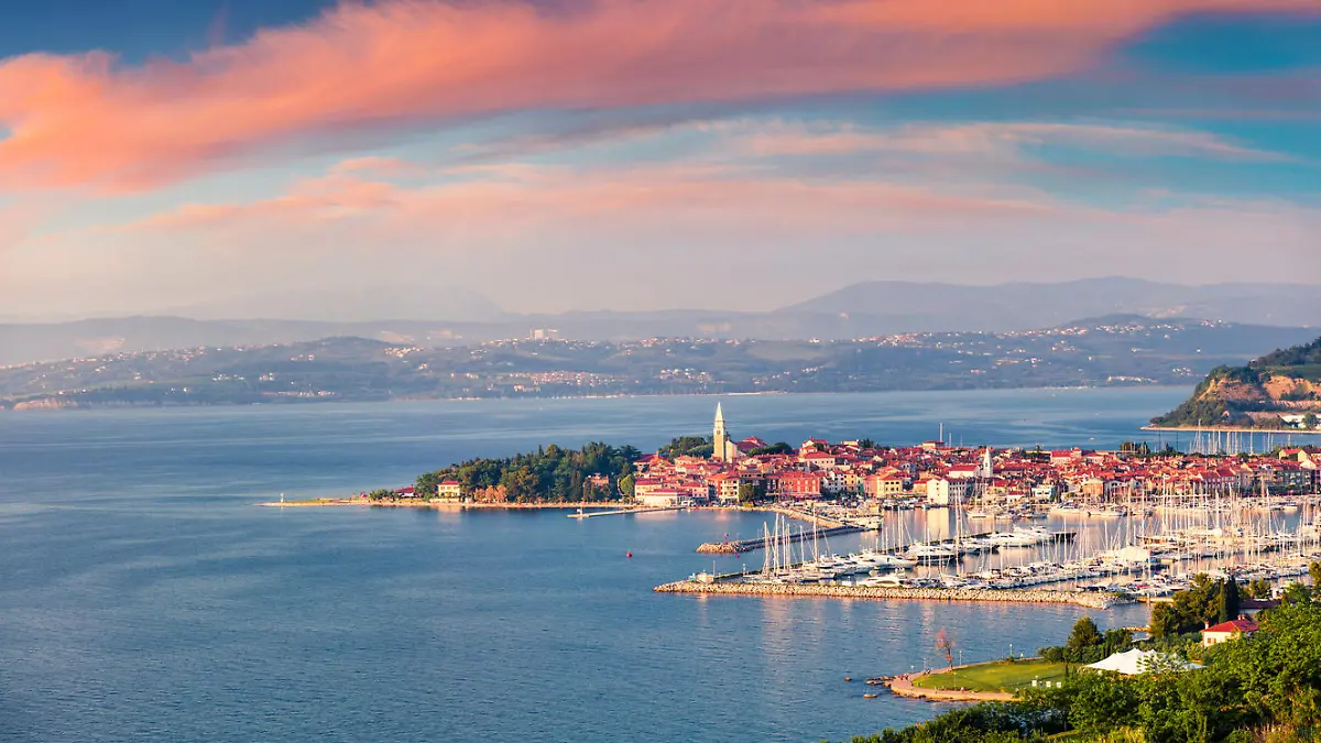 Aerial view of old fishing town Izola. Impressive spring sunset in Slovenia, Europe. Beautiful seascape Adriatic Sea. Traveling concept background.
