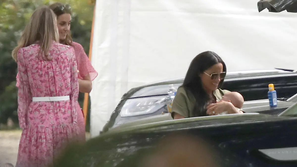King Power Royal Charity Polo Day. The Duchess of Sussex holding her son Archie watched the Duchess of Cambridge as they attend the King Power Royal Charity Polo Day at Billingbear Polo Club, Wokingham, Berkshire. Picture date: Wednesday July 10, 2019. Photo credit should read: Andrew Matthews/PA Wire URN:44026071