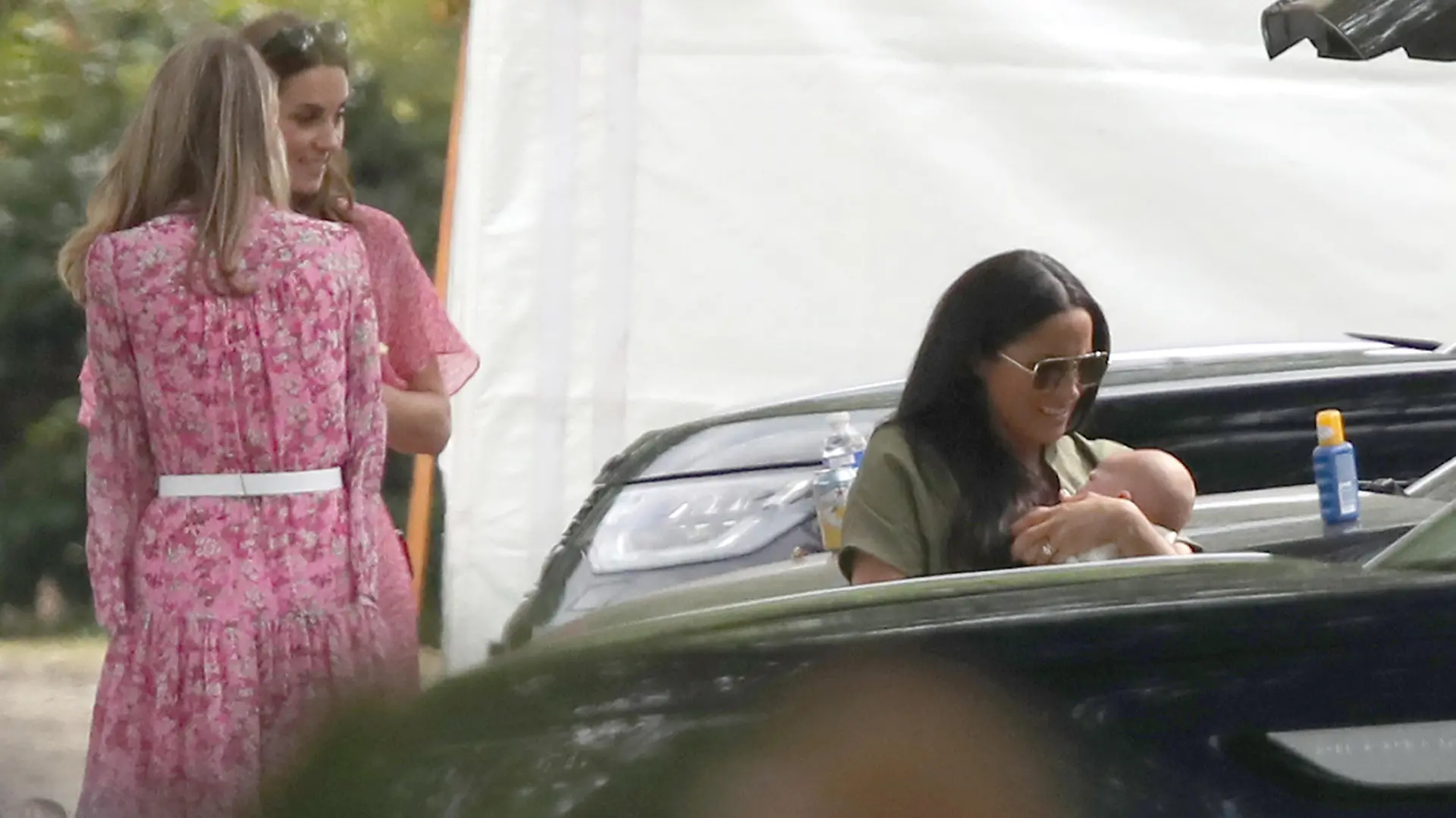 King Power Royal Charity Polo Day. The Duchess of Sussex holding her son Archie watched the Duchess of Cambridge as they attend the King Power Royal Charity Polo Day at Billingbear Polo Club, Wokingham, Berkshire. Picture date: Wednesday July 10, 2019. Photo credit should read: Andrew Matthews/PA Wire URN:44026071