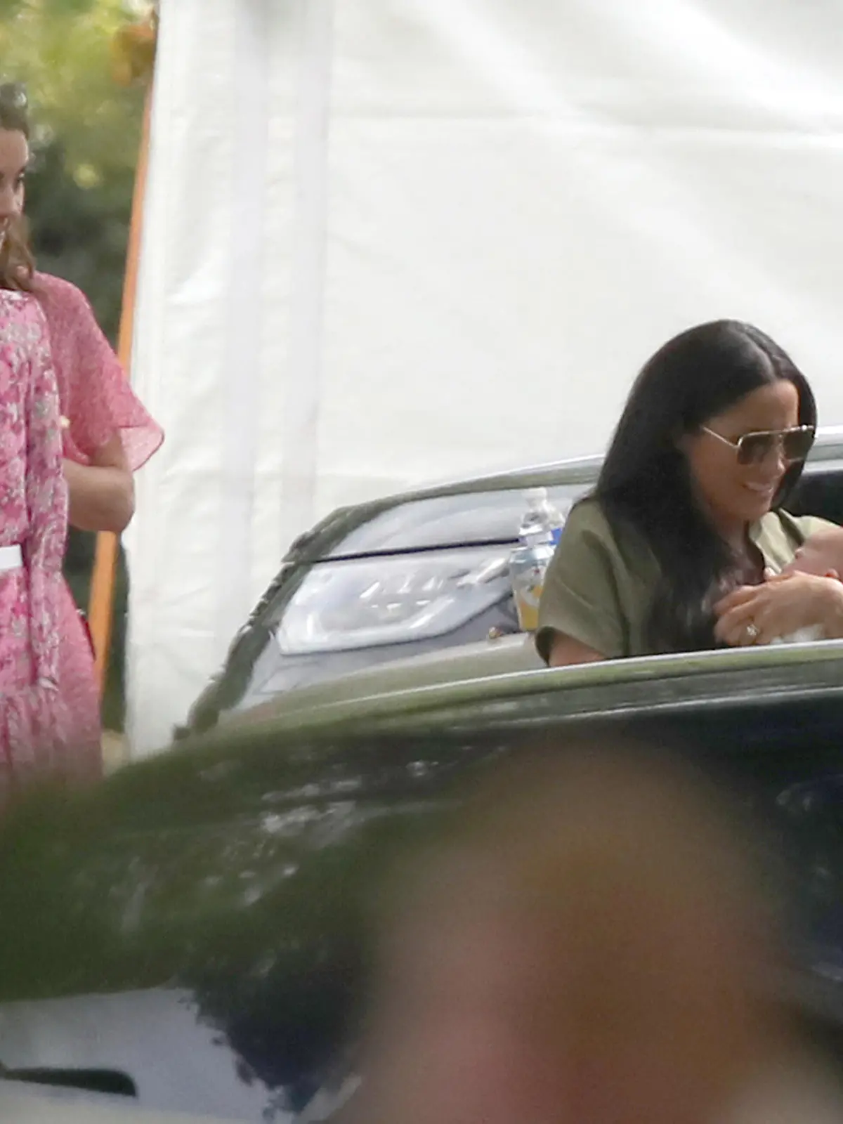 King Power Royal Charity Polo Day. The Duchess of Sussex holding her son Archie watched the Duchess of Cambridge as they attend the King Power Royal Charity Polo Day at Billingbear Polo Club, Wokingham, Berkshire. Picture date: Wednesday July 10, 2019. Photo credit should read: Andrew Matthews/PA Wire URN:44026071