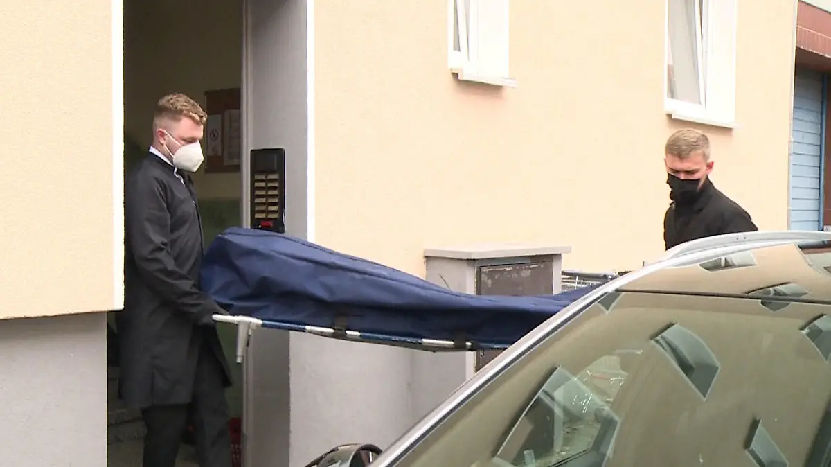 20.09.2021, Niedersachsen, Hannover: Bestatter bringen das Opfer zu ihrem Fahrzeug. Eine 53 Jahre alte Sexarbeiterin ist tot in ihrer Wohnung gefunden worden. Ein Nachbar hatte sie am Sonntagabend gefesselt auf dem Boden liegend entdeckt, wie eine Sprecherin der Polizei sagte. Foto: -/TNN/dpa +++ dpa-Bildfunk +++
