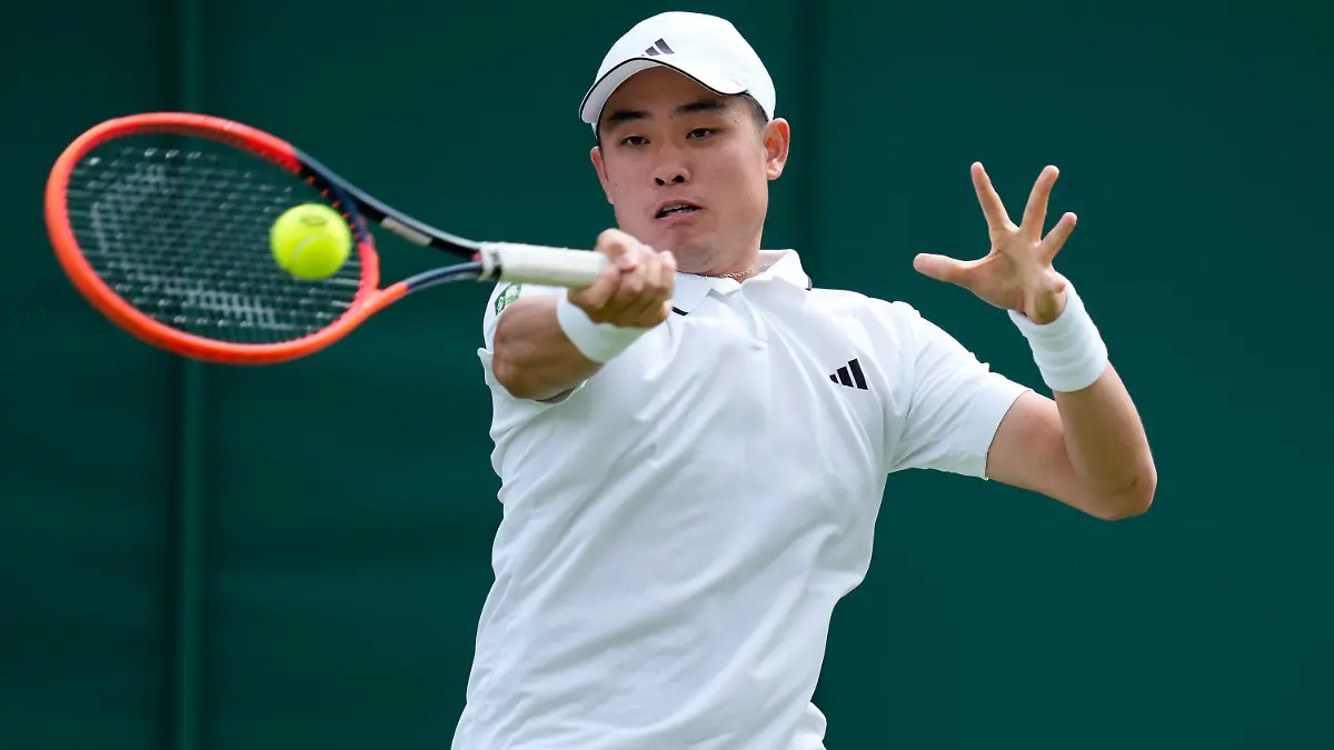 China's Wu Yibing returns to Frances Tiafoe of the US in a first round men's singles match on day three of the Wimbledon tennis championships in London, Wednesday, July 5, 2023. (AP Photo/Kirsty Wigglesworth)
