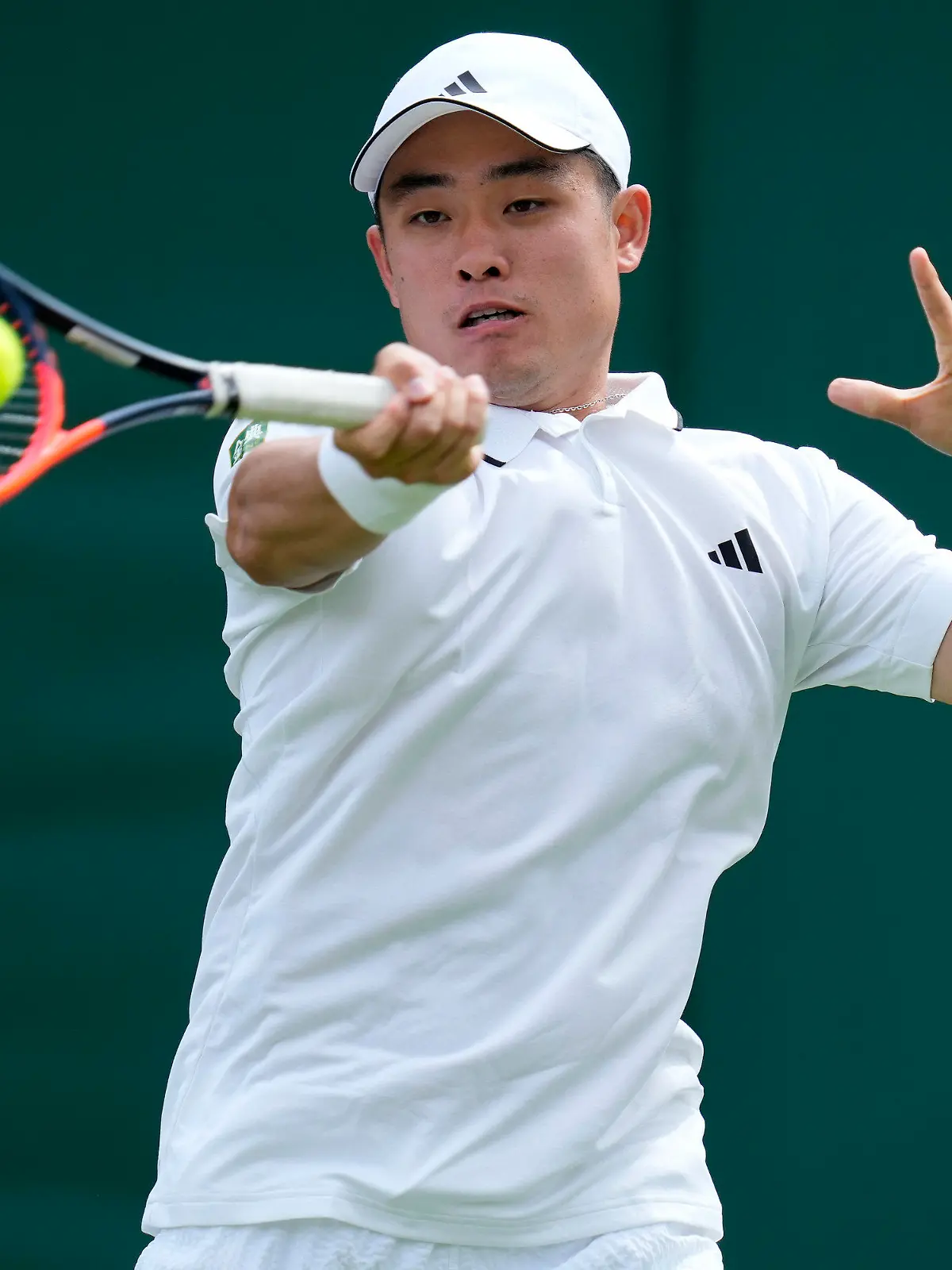 China's Wu Yibing returns to Frances Tiafoe of the US in a first round men's singles match on day three of the Wimbledon tennis championships in London, Wednesday, July 5, 2023. (AP Photo/Kirsty Wigglesworth)