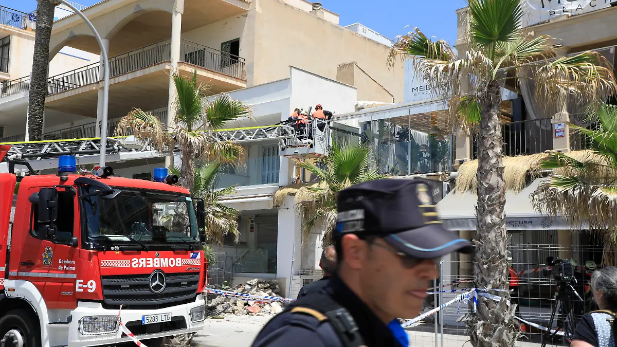 24.05.2024, Spanien, Palma: Polizeibeamte stehen nach dem Einsturz vor dem Gebäude des Medusa Beach Club. Zwei deutsche Frauen und zwei weitere Personen sind beim Einsturz des Restaurants an der Playa de Palma auf Mallorca ums Leben gekommen.  