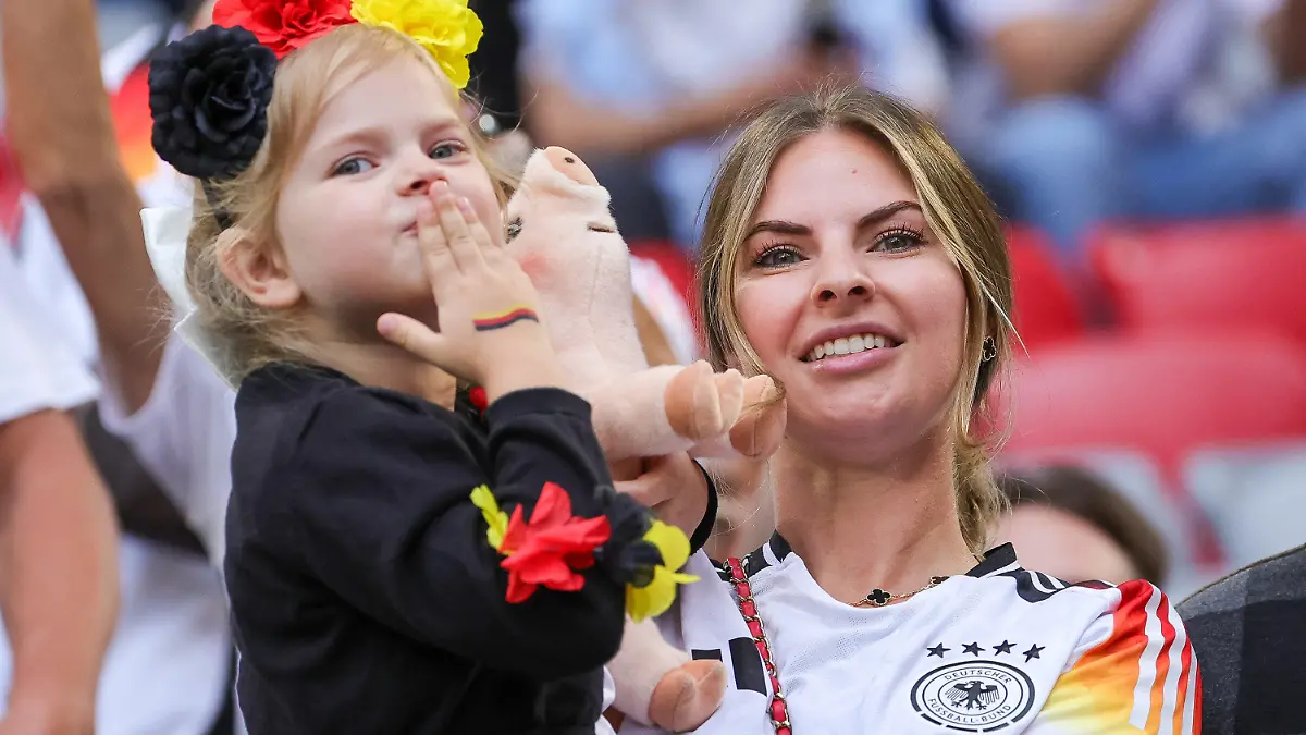 14.06.2024, Bayern, München: Fußball, UEFA Euro 2024, EM, Deutschland - Schottland, Vorrunde, Gruppe A, Spieltag 1, Fußball Arena München. Die deutsche Spielerfrau Lisa Füllkrug winkt mit Tochter Emilia vor dem Spiel. Foto: Christian Charisius/dpa +++ dpa-Bildfunk +++